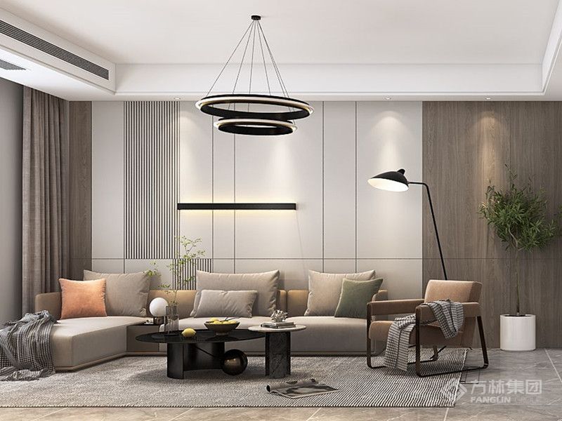 穿过玄关步入开放的起居空间，同一材质通过不同的处理方式，大面积应用于沙发背景墙，硬包结合木饰面墙板产生碰撞，理性的线条赋予空间现代感的氛围。